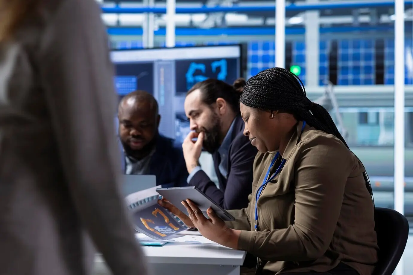 Руководители фотовольтаического завода с помощью планшета изучают схемы.